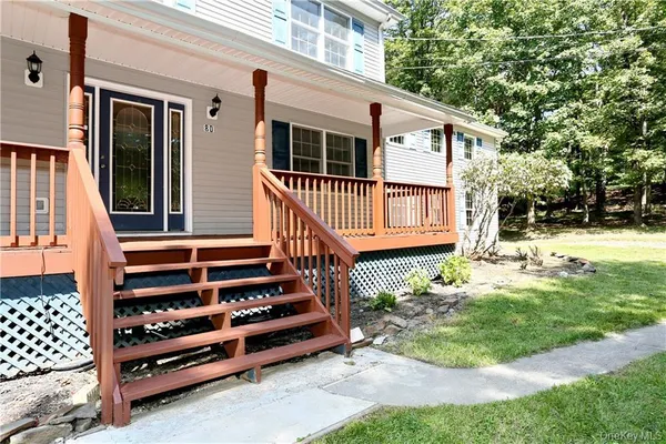 a front view of a house with a yard table and chair