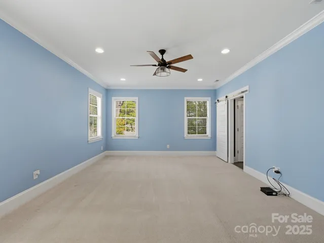 a view of a livingroom with a ceiling fan and window