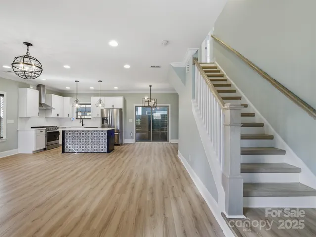 a view of kitchen with sink and refrigerator