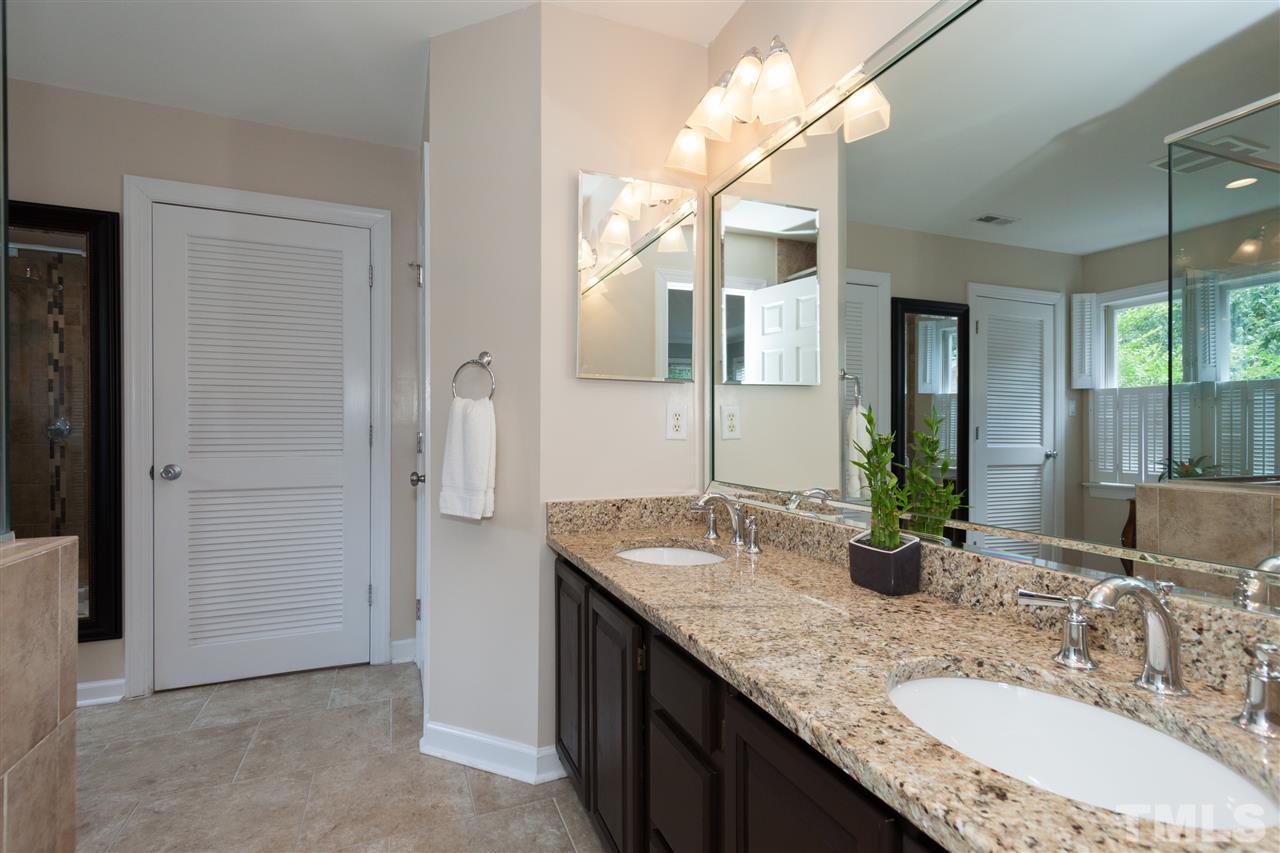 5817 Raddington Street Raleigh, NC 27613 - Photo 15 of 25 a bathroom with a granite countertop sink and a mirror