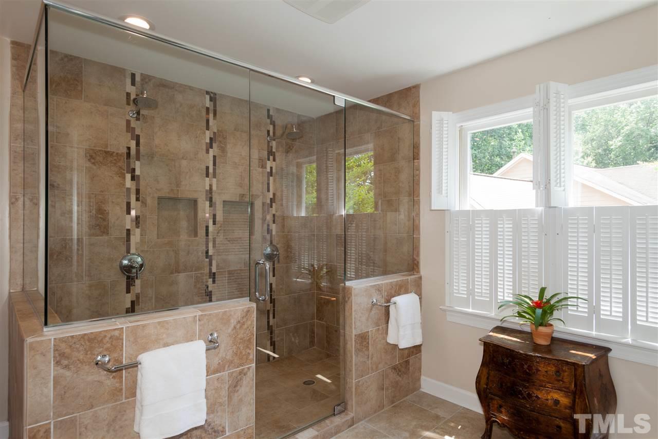 5817 Raddington Street Raleigh, NC 27613 - Photo 16 of 25 a bathroom with a shower and a tub