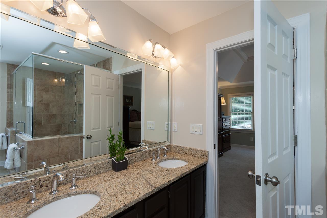 5817 Raddington Street Raleigh, NC 27613 - Photo 17 of 25 a bathroom with a granite countertop sink and a mirror