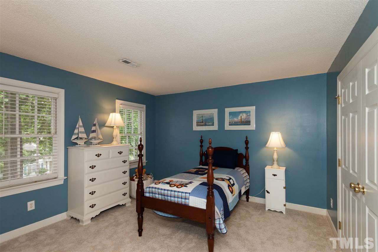 5817 Raddington Street Raleigh, NC 27613 - Photo 19 of 25 a bedroom with a bed and a window