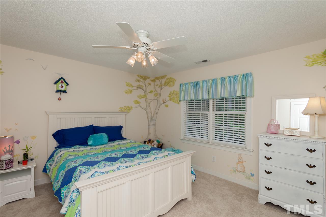 5817 Raddington Street Raleigh, NC 27613 - Photo 21 of 25 a bedroom with a bed and a dresser