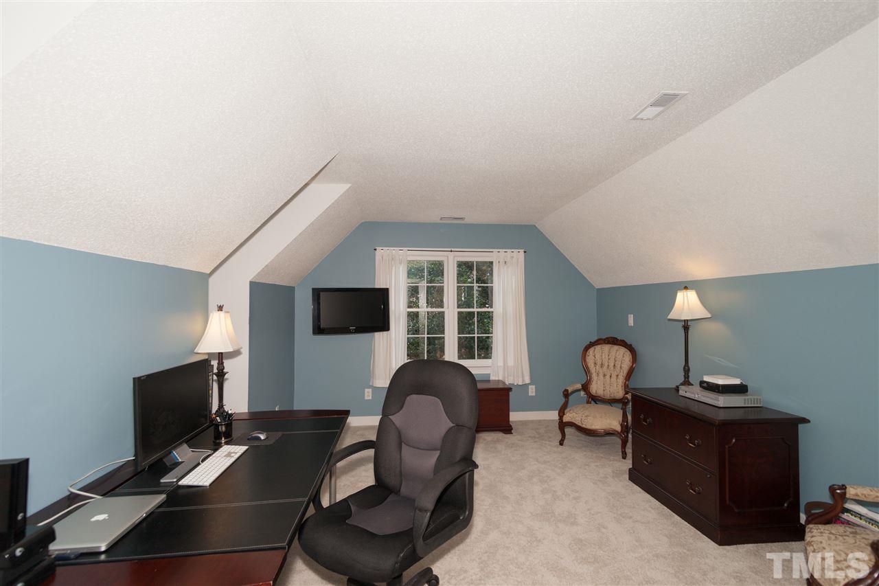5817 Raddington Street Raleigh, NC 27613 - Photo 22 of 25 a work room with furniture and a flat screen tv