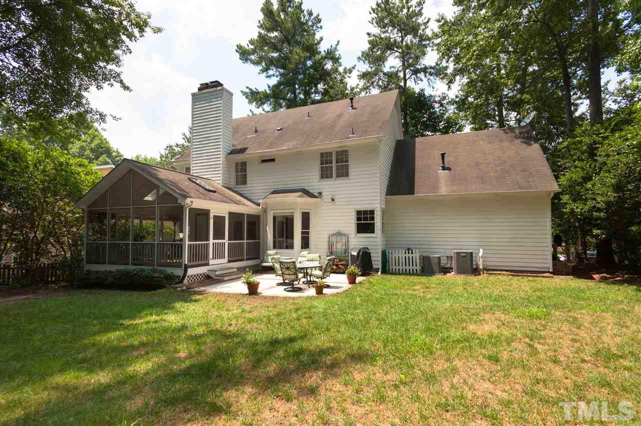5817 Raddington Street Raleigh, NC 27613 - Photo 24 of 25 a front view of house with yard and trees in the background