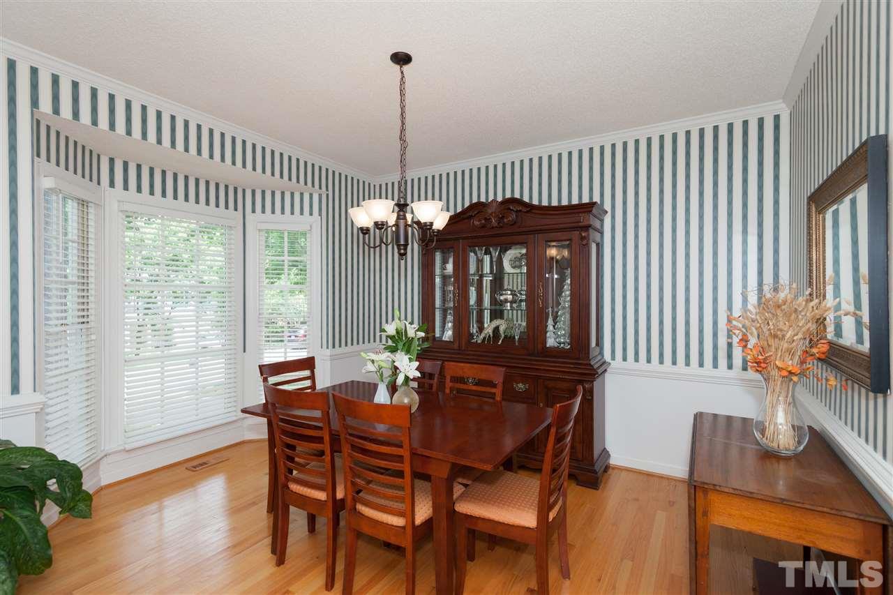 5817 Raddington Street Raleigh, NC 27613 - Photo 5 of 25 a view of a dining room with furniture window and wooden floor