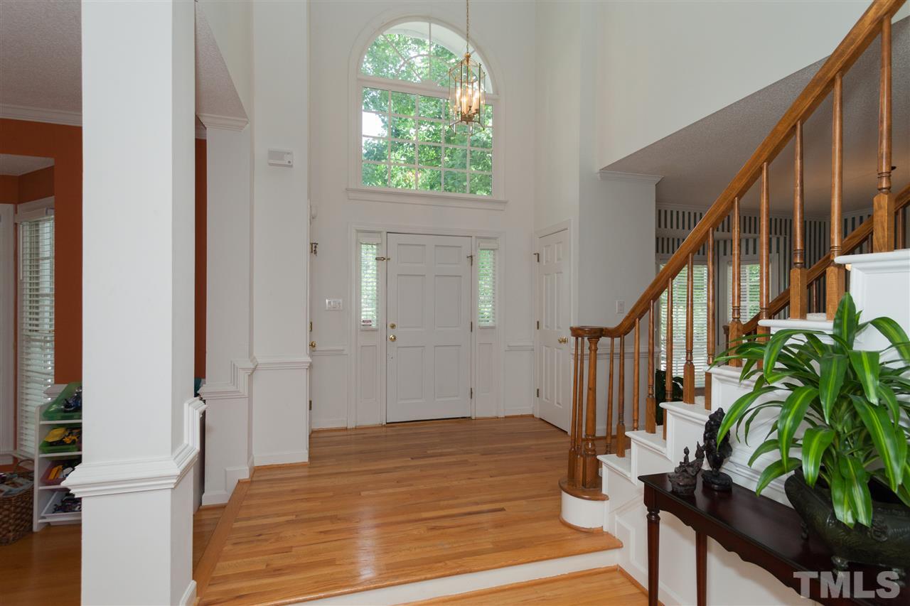 5817 Raddington Street Raleigh, NC 27613 - Photo 6 of 25 a view of an entryway with wooden floor and front door