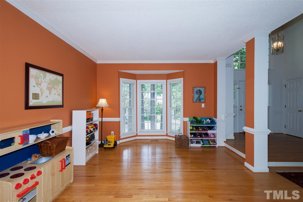 5817 Raddington Street Raleigh, NC 27613 - Photo 7 of 25 a view of an empty room with window and a flat screen tv