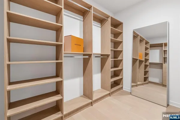a view of walk in closet with empty racks