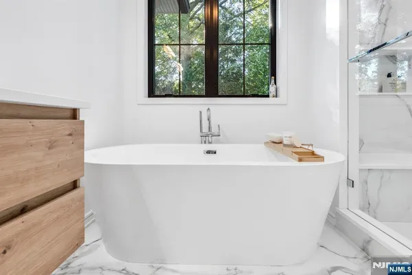 a white bath tub sitting next to a white sink