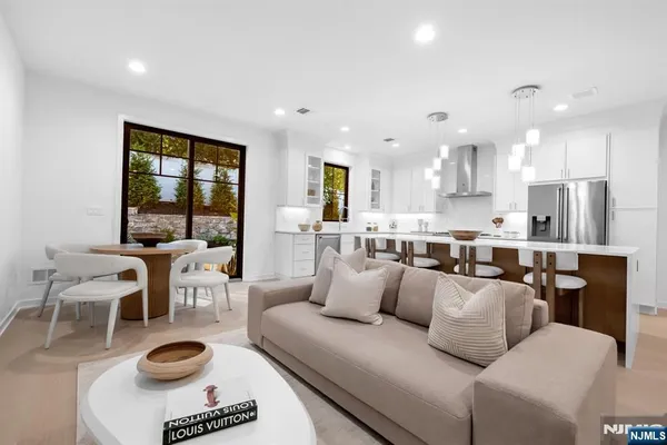 a living room with furniture a large window and a table