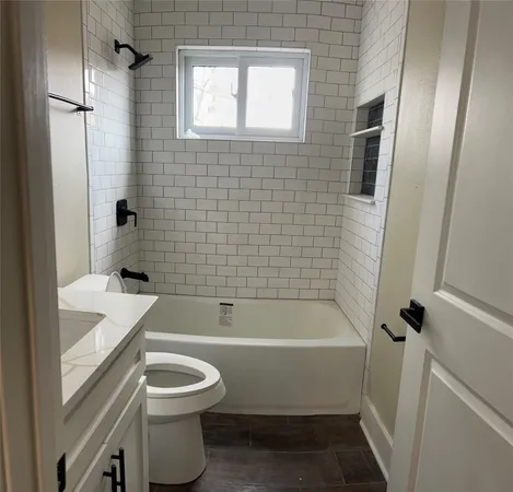 a bathroom with a toilet a sink and bathtub