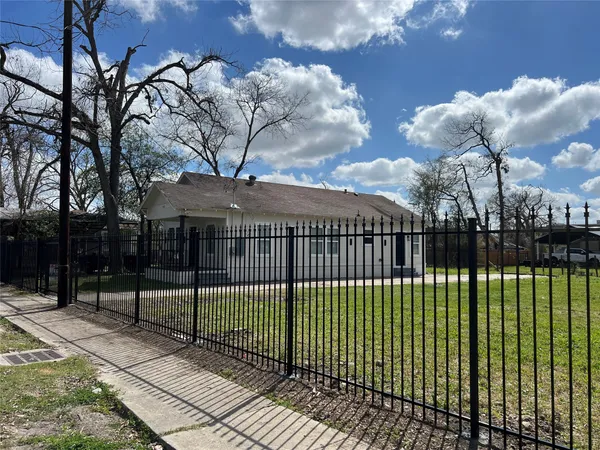 a view of a house with a iron fence