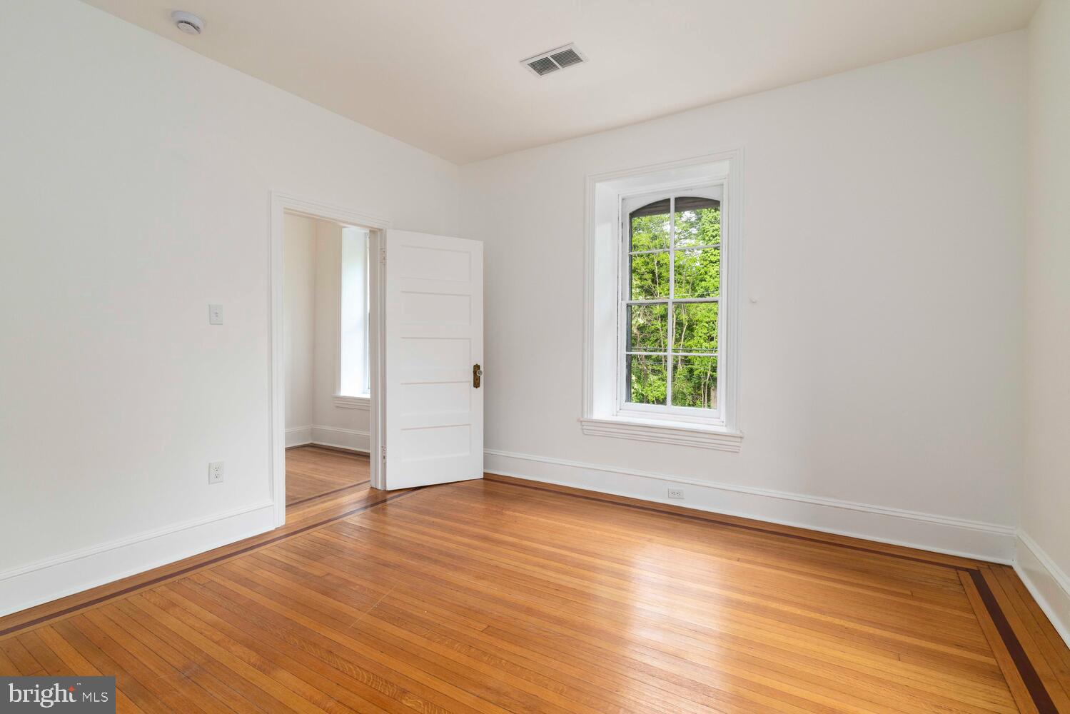 28 East Johnson Street Philadelphia, PA 19144 - Photo 17 of 24 a view of an empty room with wooden floor and a window