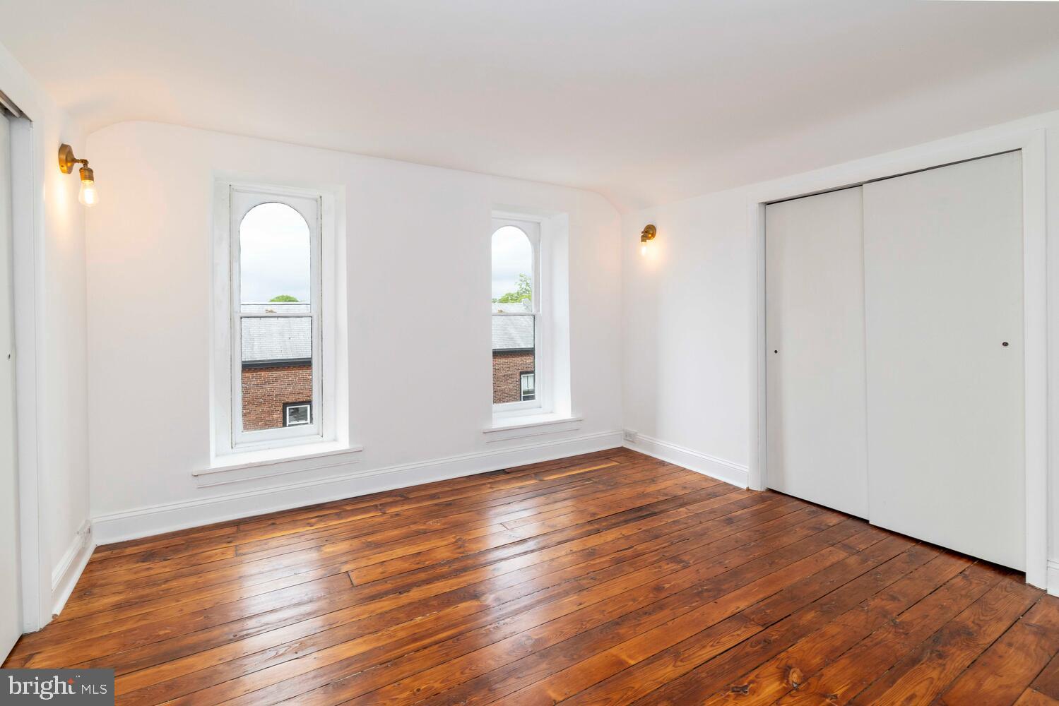 28 East Johnson Street Philadelphia, PA 19144 - Photo 22 of 24 a view of an empty room with wooden floor and a window