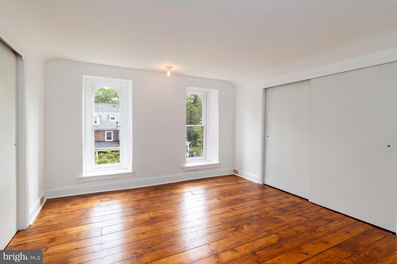 28 East Johnson Street Philadelphia, PA 19144 - Photo 23 of 24 a view of an empty room with wooden floor and a window