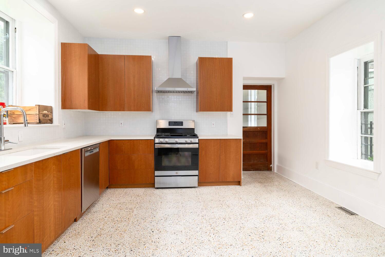 28 East Johnson Street Philadelphia, PA 19144 - Photo 7 of 24 a kitchen with stainless steel appliances granite countertop a sink and a stove with granite countertops