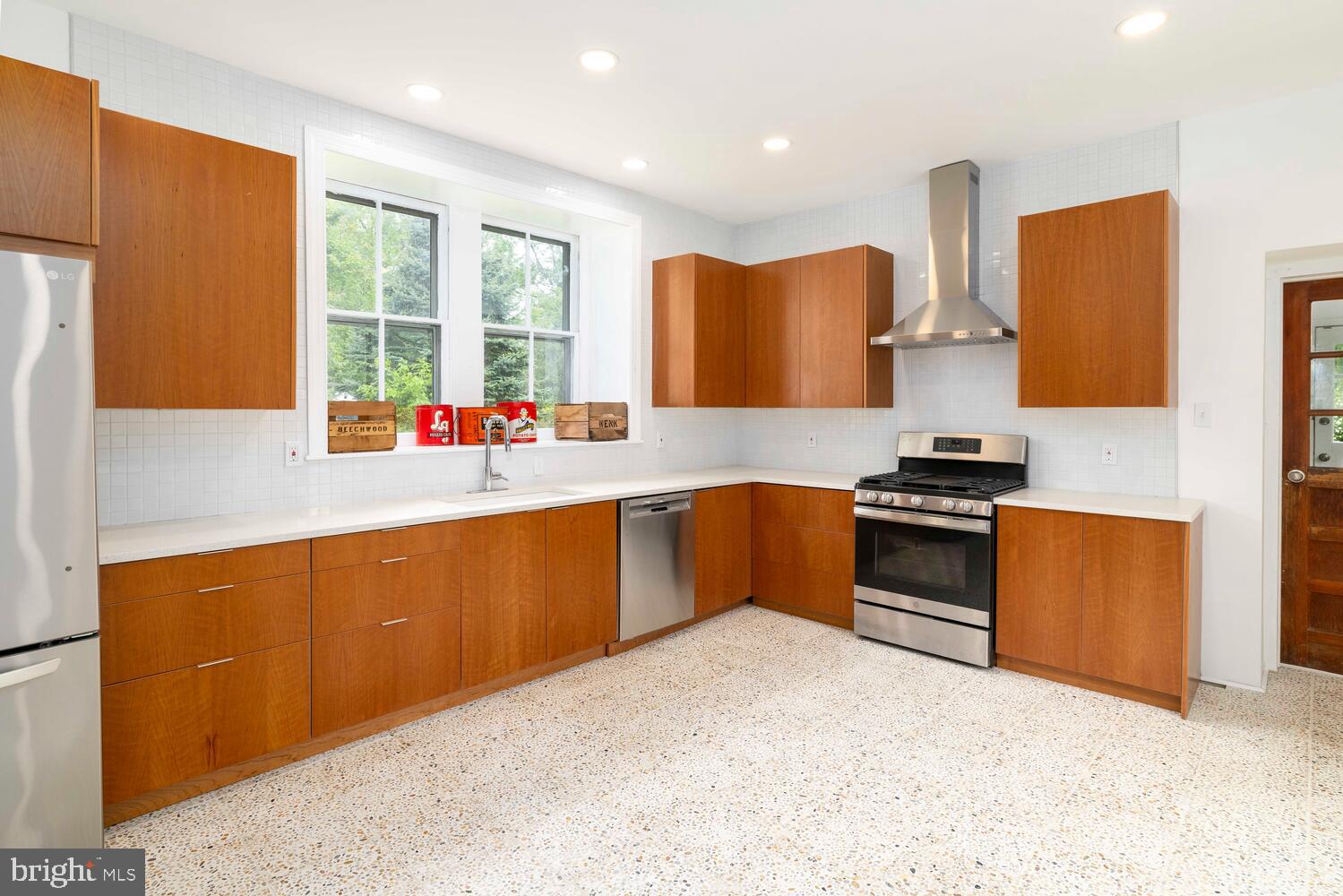 28 East Johnson Street Philadelphia, PA 19144 - Photo 8 of 24 a kitchen with stainless steel appliances kitchen island granite countertop a sink stove and refrigerator