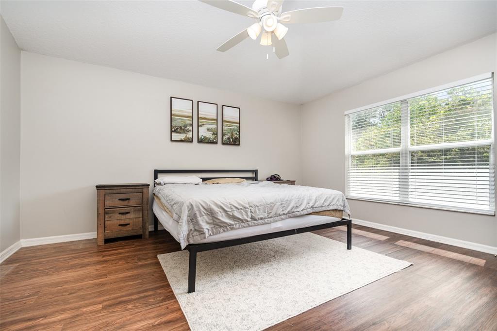 149 Circle Hill Road Sanford, FL 32746 - Photo 12 of 30 a bedroom with a bed and wooden floor