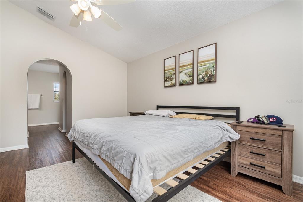 149 Circle Hill Road Sanford, FL 32746 - Photo 15 of 30 a bedroom with a bed and a chandelier