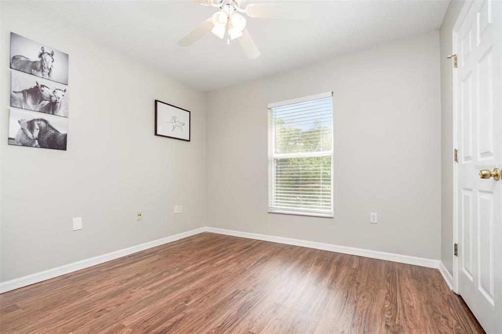 149 Circle Hill Road Sanford, FL 32746 - Photo 21 of 30 a view of an empty room with wooden floor and a window