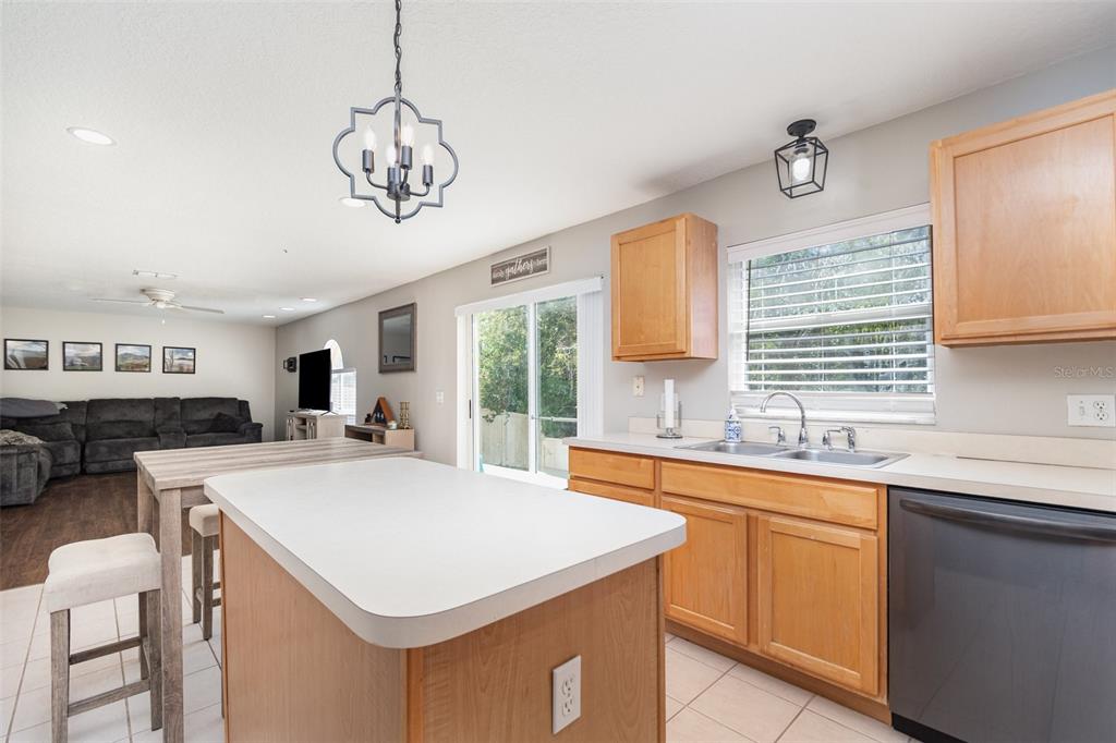149 Circle Hill Road Sanford, FL 32746 - Photo 7 of 30 a kitchen with a stove a sink a dining table and chairs