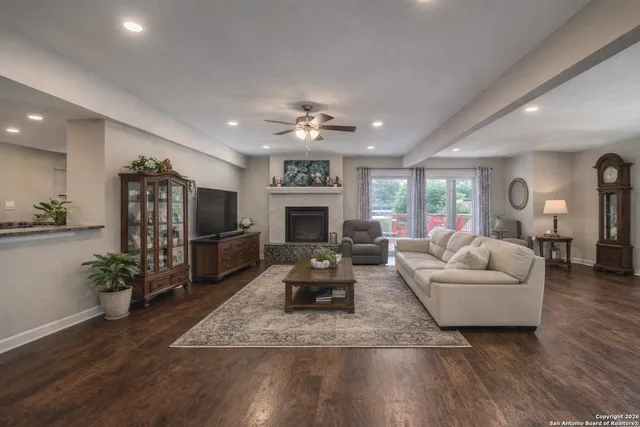 a living room with furniture fireplace and flat screen tv