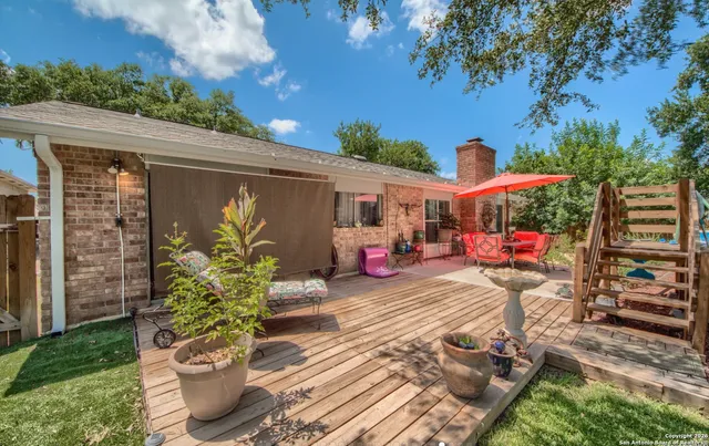 a view of a patio with table and chairs potted plants