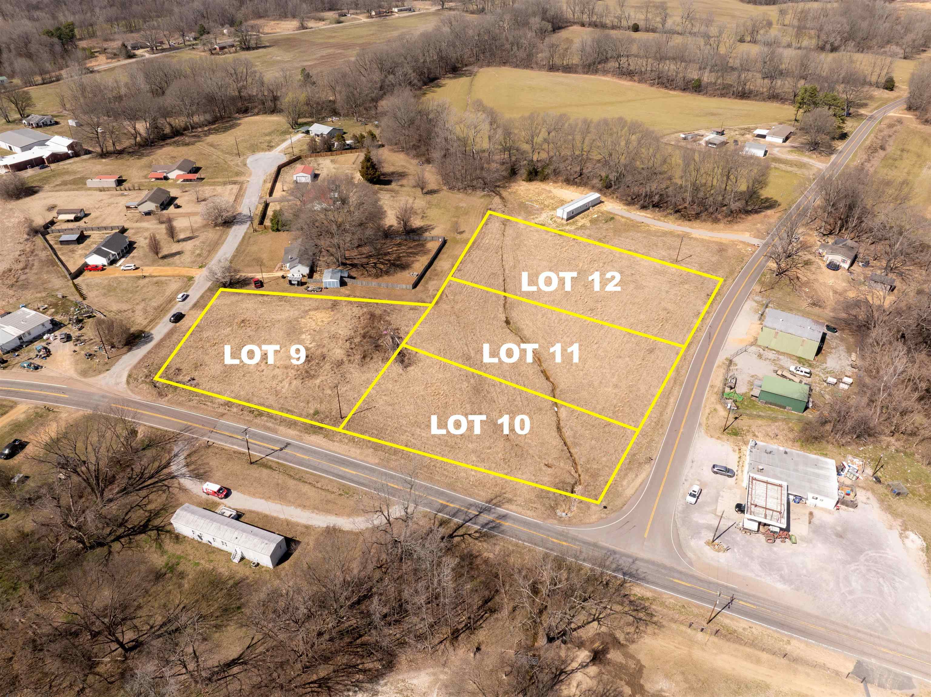 Lot #10 Luckett Three Points Road Henning, TN 38041 - Photo 2 of 15 with a book on the side of the road