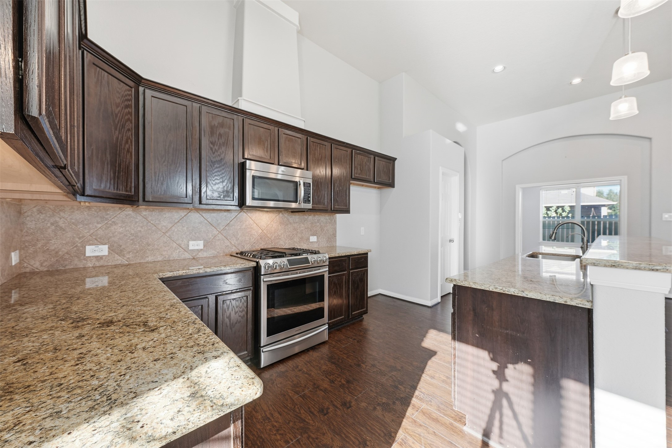 6011 Watford Bend Rosenberg, TX 77471 - Photo 19 of 48 a kitchen with stainless steel appliances granite countertop a stove a sink and a microwave