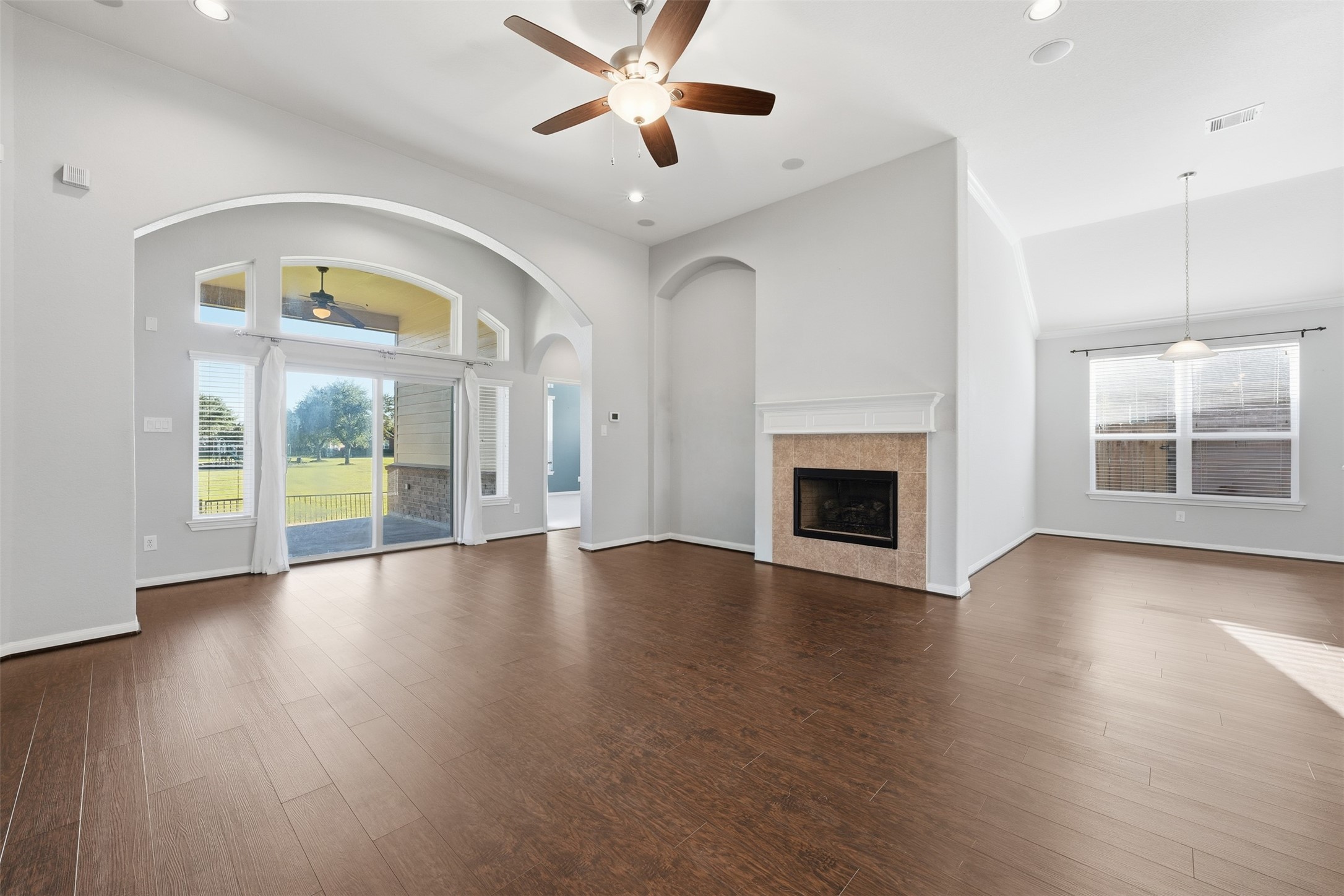 6011 Watford Bend Rosenberg, TX 77471 - Photo 26 of 48 an empty room with wooden floor a ceiling fan and windows