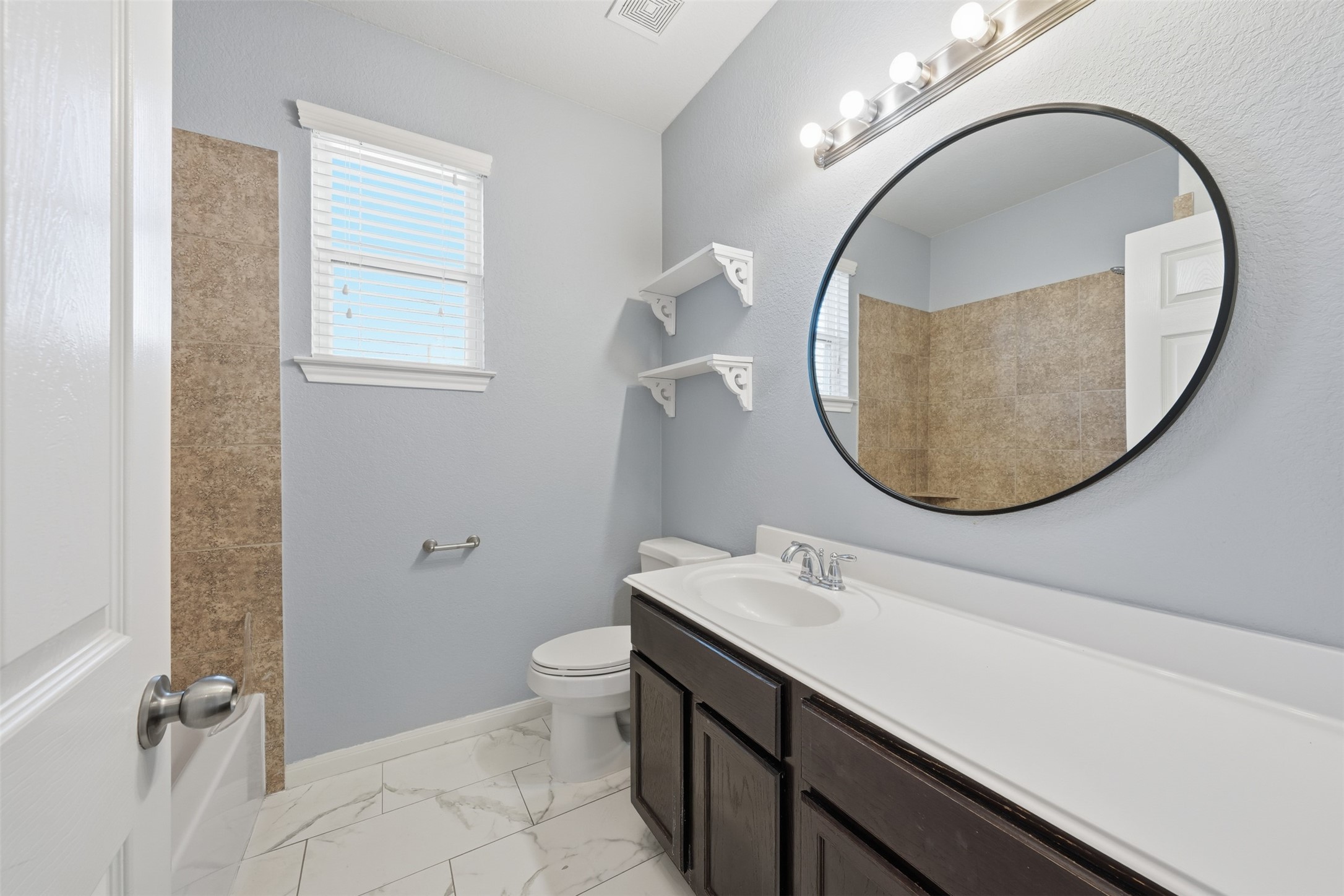 6011 Watford Bend Rosenberg, TX 77471 - Photo 36 of 48 a bathroom with a sink a mirror a vanity and a toilet