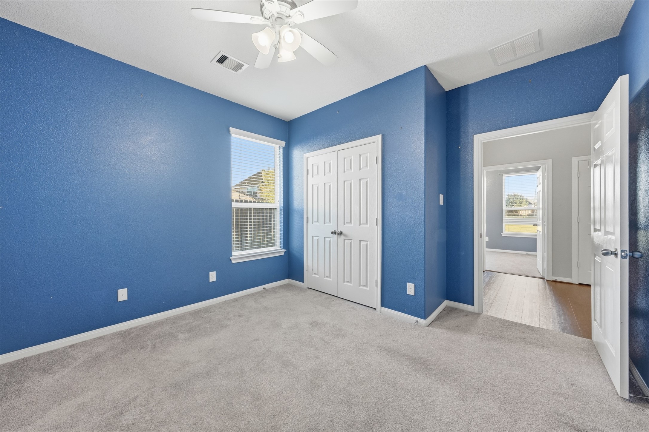 6011 Watford Bend Rosenberg, TX 77471 - Photo 39 of 48 a view of an empty room with chandelier fan and a bathroom
