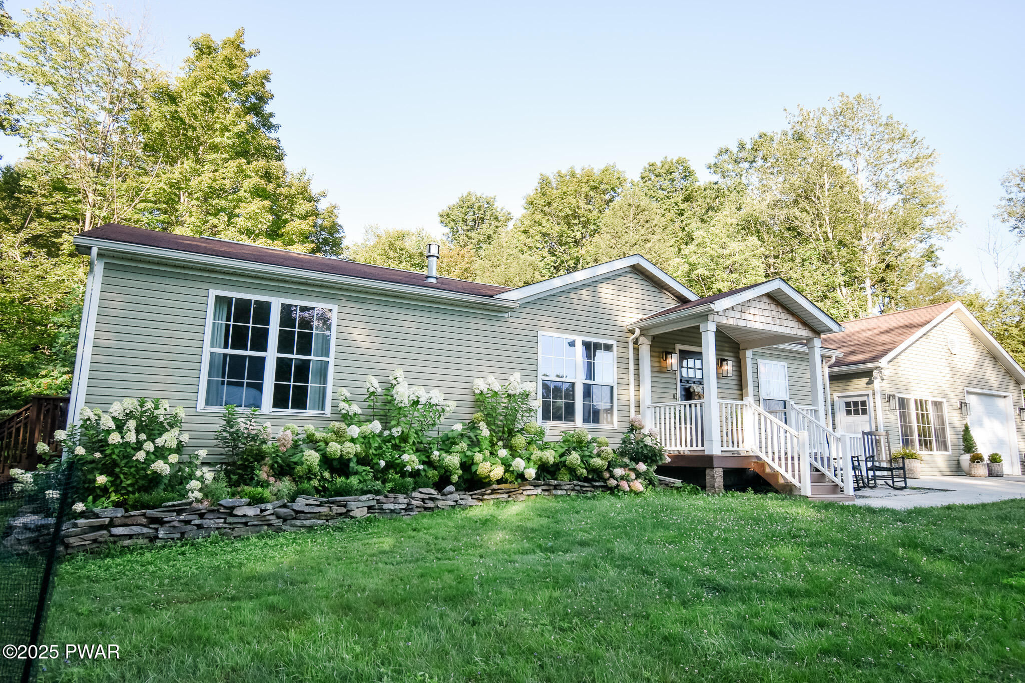 66 Wash Road Waymart, PA 18472 - Photo 4 of 41 a front view of a house with a yard and trees