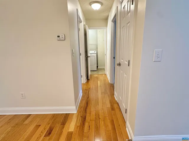 a view of a hallway with wooden floor