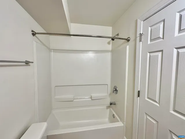 a bathroom with a shower and a bath tub