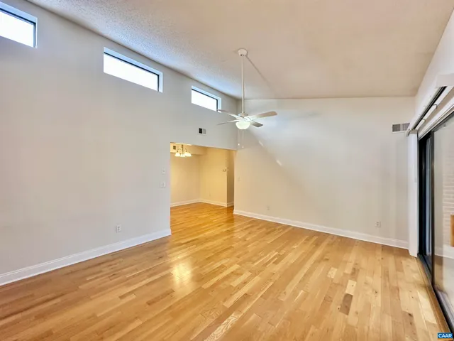 a view of empty room with wooden floor