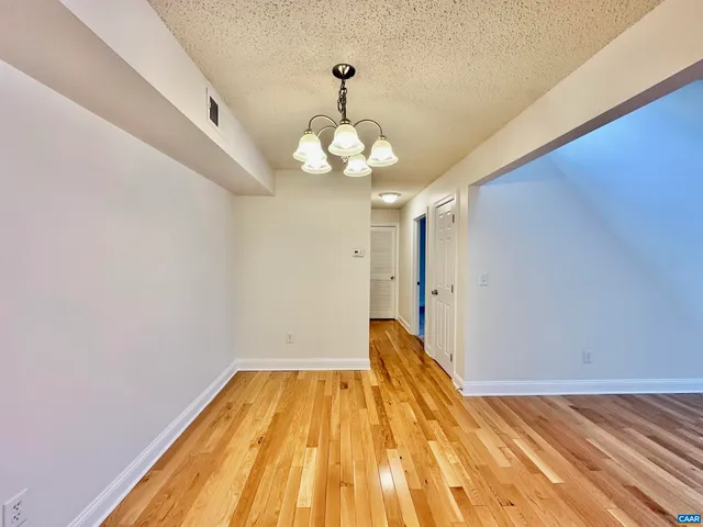 a view of a room with wooden floor and staircase
