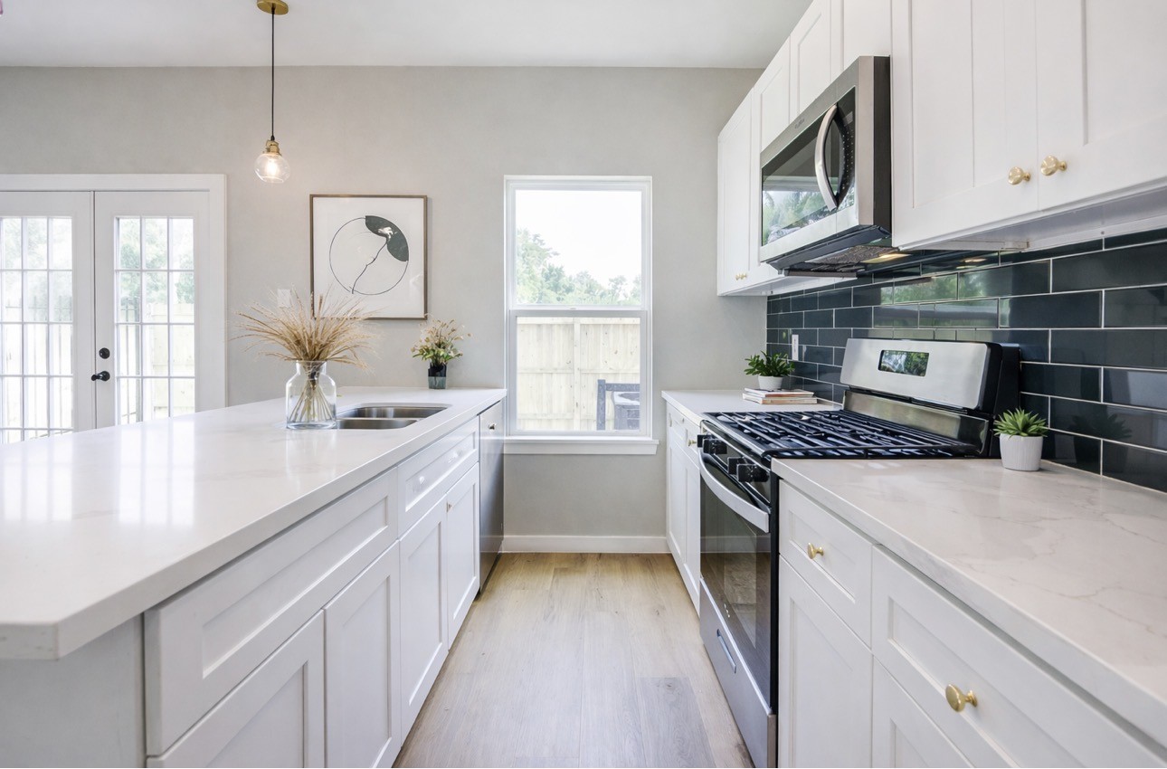 8361 Tate Street Houston, TX 77028 - Photo 2 of 16 a kitchen with kitchen island granite countertop lots of counter top space and stainless steel appliances