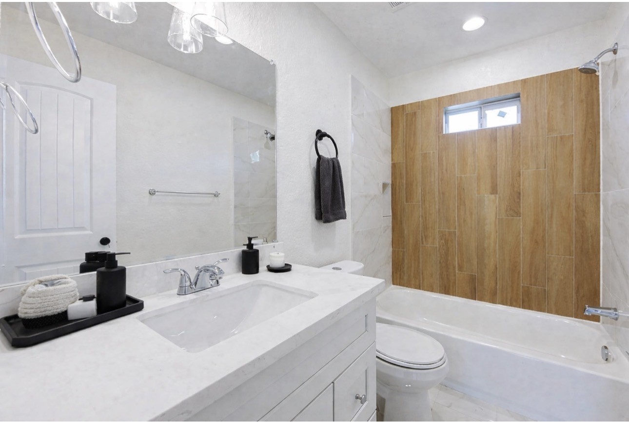 8361 Tate Street Houston, TX 77028 - Photo 6 of 16 a bathroom with a sink a toilet and shower