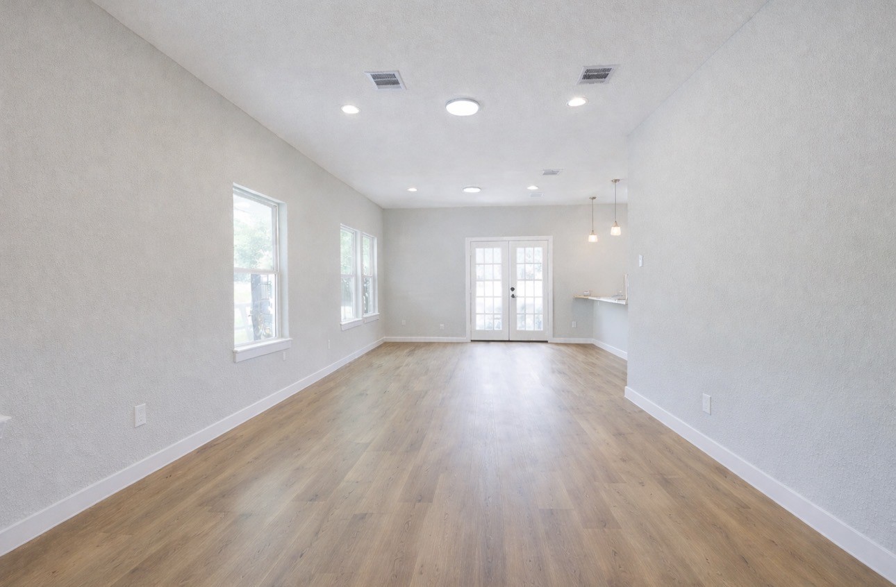 8361 Tate Street Houston, TX 77028 - Photo 7 of 16 an empty room with wooden floor and windows