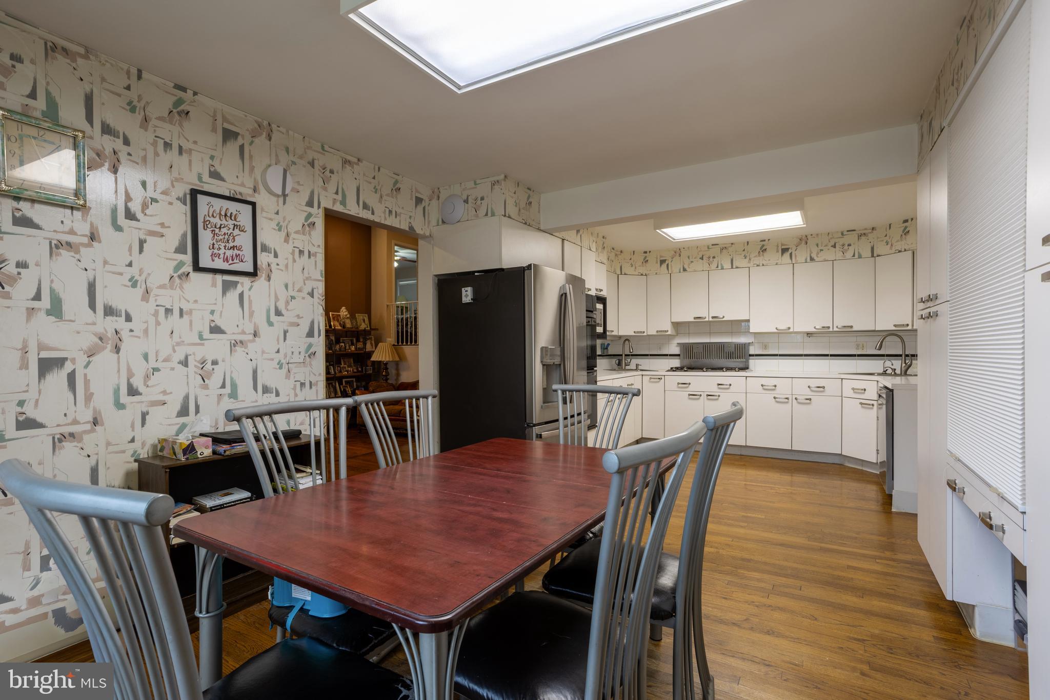 3215 Northbrook Road Baltimore, MD 21208 - Photo 12 of 48 a kitchen with stainless steel appliances a dining table chairs and refrigerator