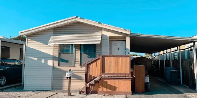 a blue and white umbrella sitting in front of a house