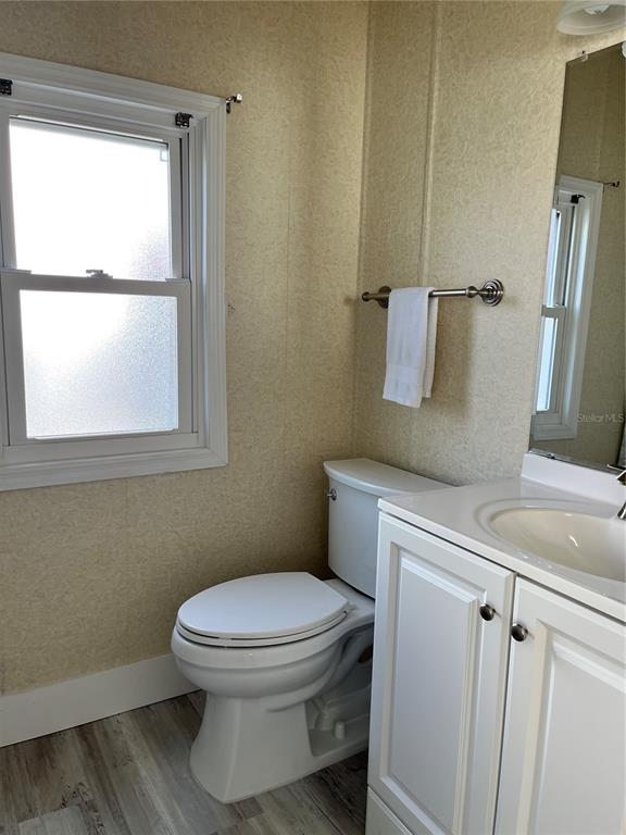 6803 Mt Pleasant Road Northeast, Unit 33 St. Petersburg, FL 33702 - Photo 12 of 28 a bathroom with a toilet sink and window