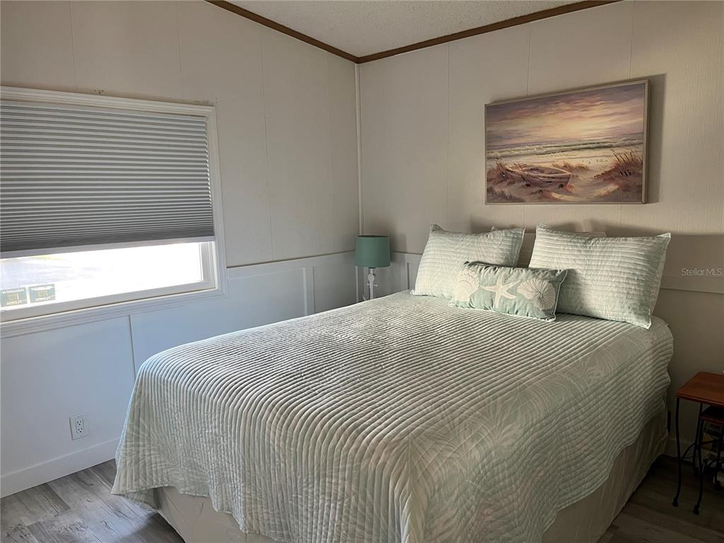 6803 Mt Pleasant Road Northeast, Unit 33 St. Petersburg, FL 33702 - Photo 13 of 28 a bedroom with a bed and a window