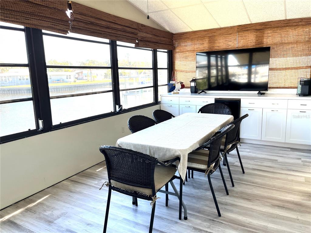 6803 Mt Pleasant Road Northeast, Unit 33 St. Petersburg, FL 33702 - Photo 15 of 28 a view of a dining room with furniture window and wooden floor