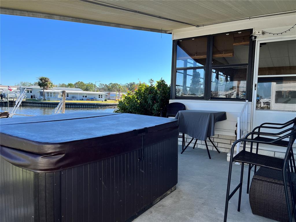 6803 Mt Pleasant Road Northeast, Unit 33 St. Petersburg, FL 33702 - Photo 18 of 28 a view of a chairs and table in the patio