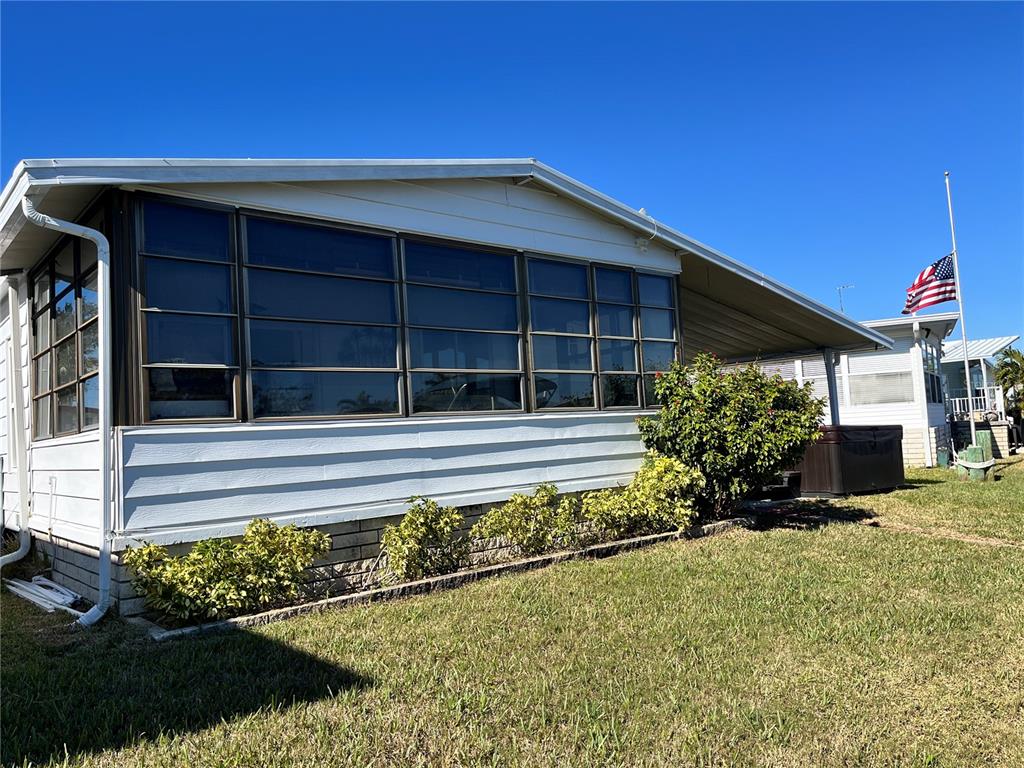 6803 Mt Pleasant Road Northeast, Unit 33 St. Petersburg, FL 33702 - Photo 20 of 28 a front view of a house with a yard