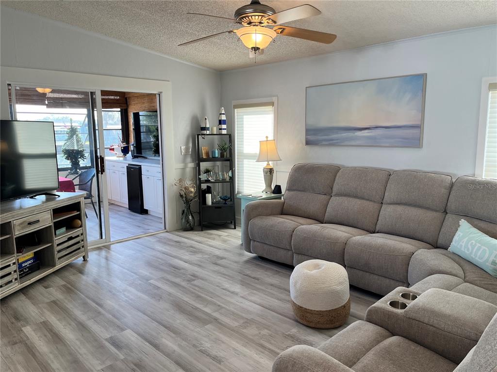 6803 Mt Pleasant Road Northeast, Unit 33 St. Petersburg, FL 33702 - Photo 5 of 28 a living room with furniture and a flat screen tv